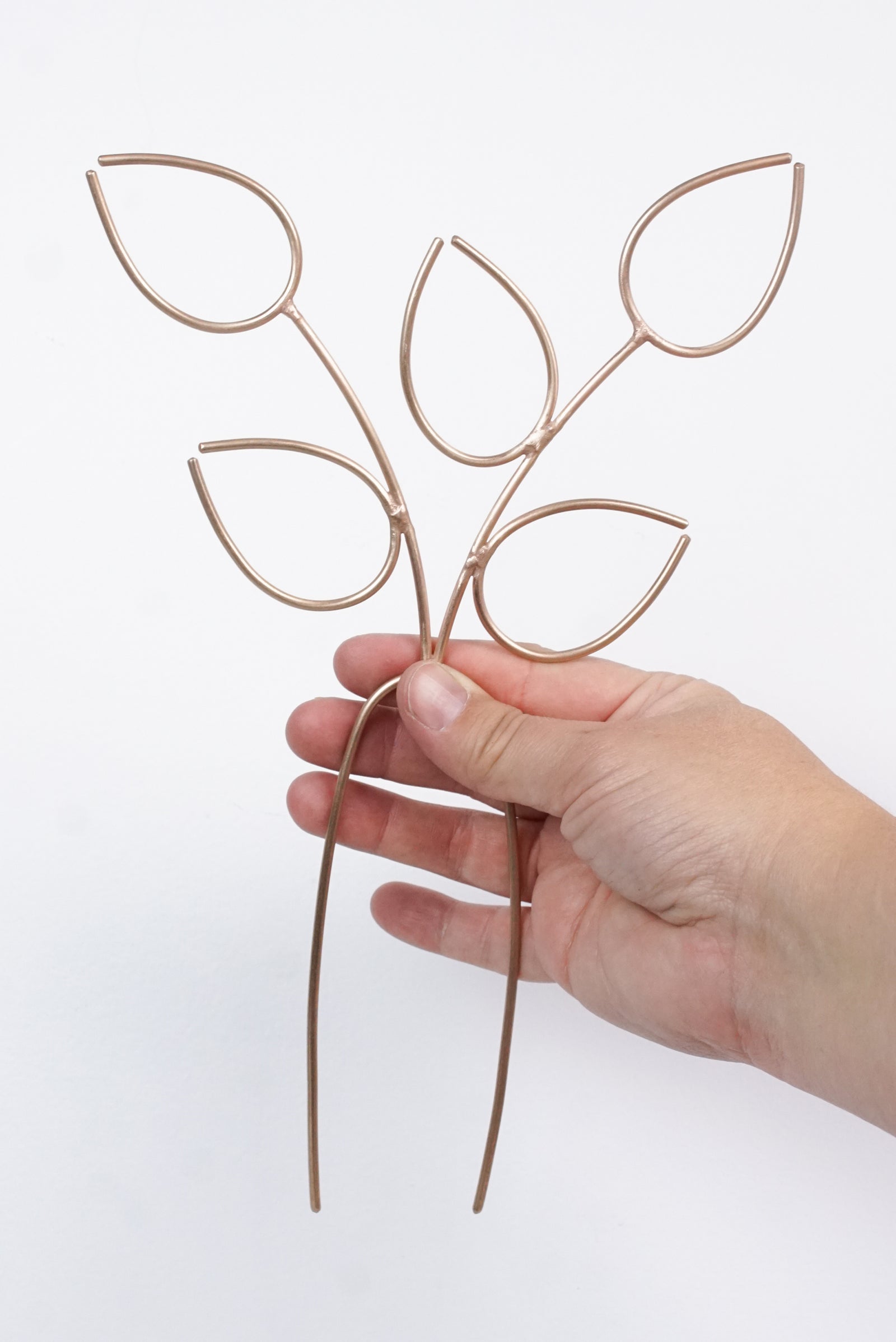 handcrafted bronze plant stake indoor trellis with vining philodendron plant